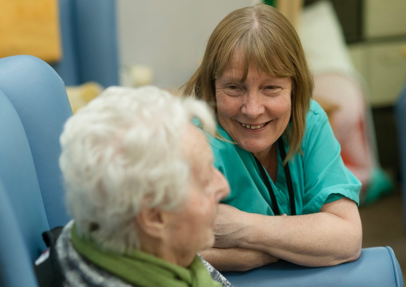 Certified home health aide assisting a senior woman with personal care and daily living